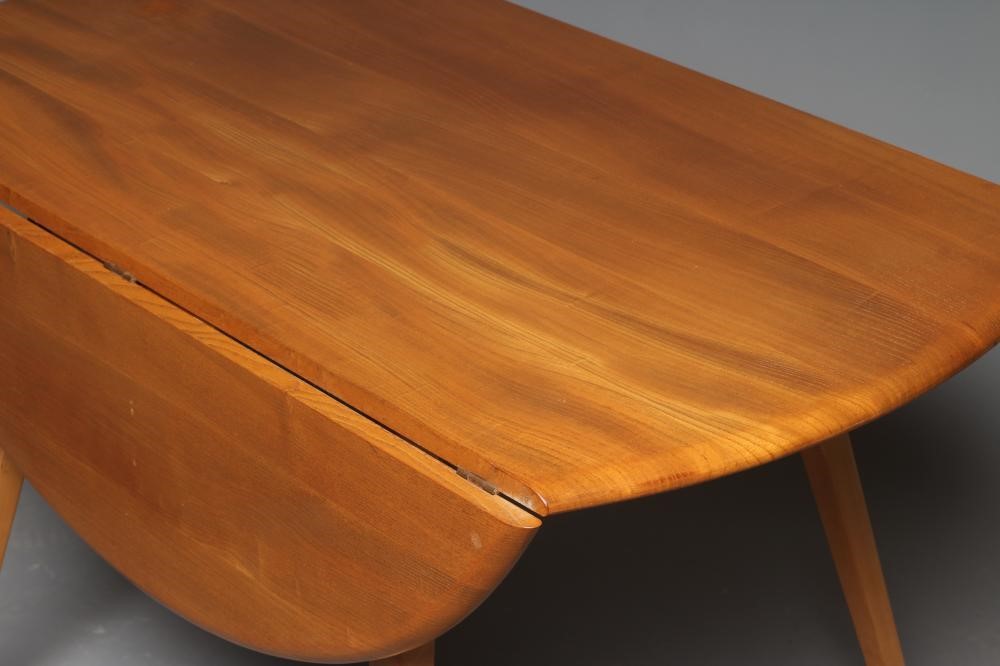 AN ERCOL LIGHT ELM DINING TABLE AND "SHALSTONE" CHAIRS Image