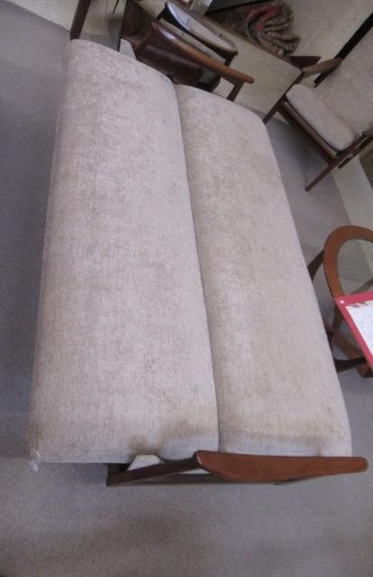 A RETRO TEAK FRAMED LOUNGE SUITE, c.1960's, upholstered in a pale mushroom chenille, comprising a Image