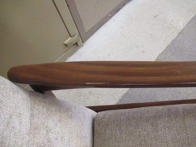 A RETRO TEAK FRAMED LOUNGE SUITE, c.1960's, upholstered in a pale mushroom chenille, comprising a Image