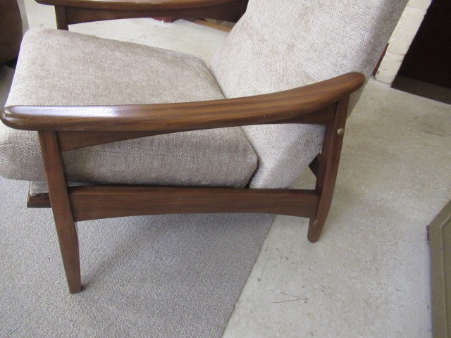 A RETRO TEAK FRAMED LOUNGE SUITE, c.1960's, upholstered in a pale mushroom chenille, comprising a Image