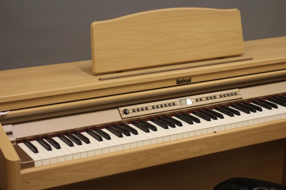 A roland hp2e digital piano, modern, serial number zr61208, in light ...