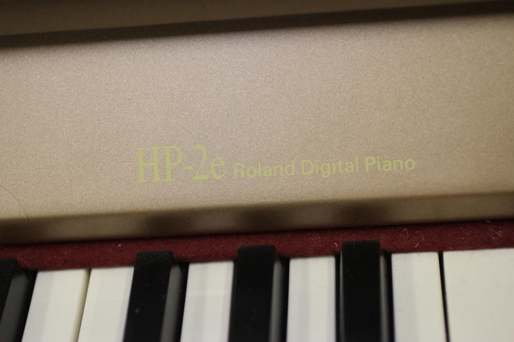 A roland hp2e digital piano, modern, serial number zr61208, in light ...