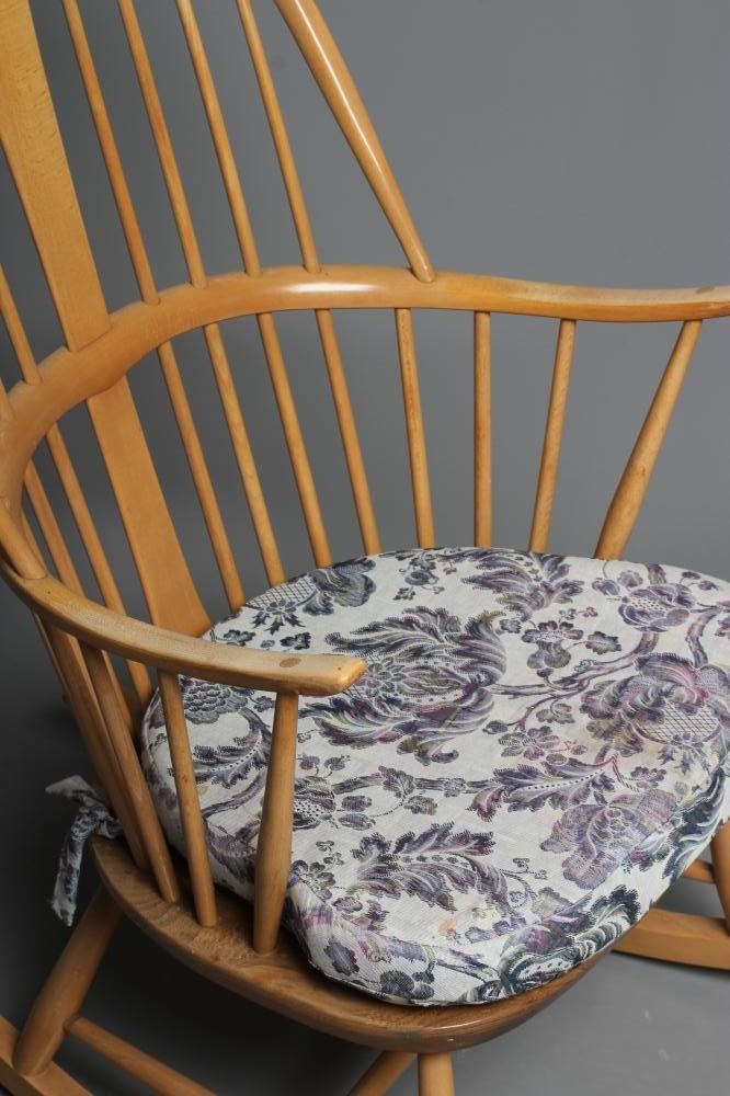 AN ERCOL COW HORN ROCKING CHAIR, mid 20th century, in blond beech and elm, the high hooped spindle Image