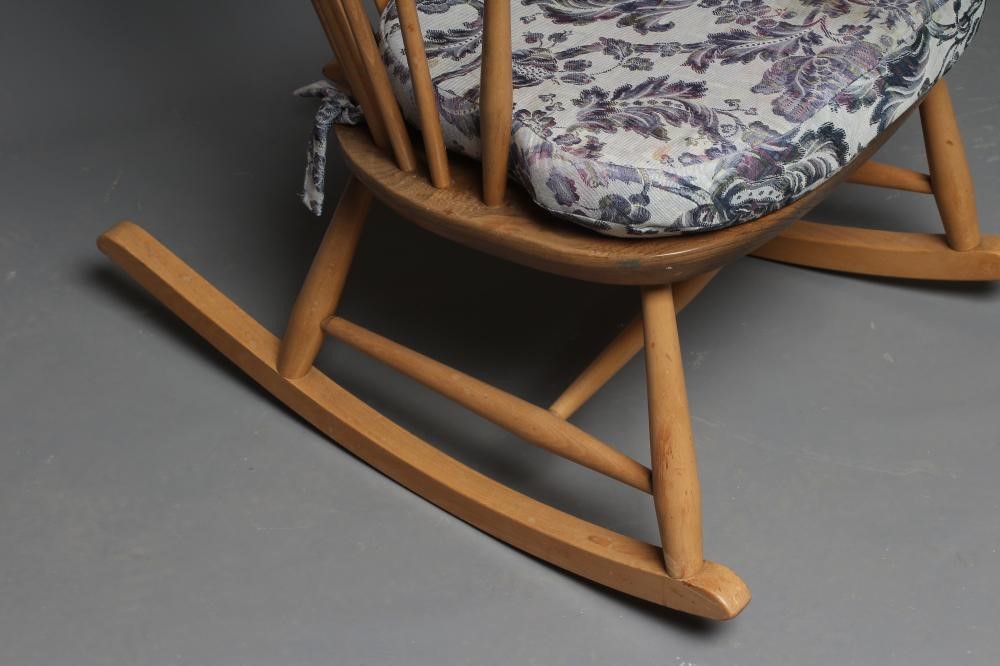 AN ERCOL COW HORN ROCKING CHAIR, mid 20th century, in blond beech and elm, the high hooped spindle Image