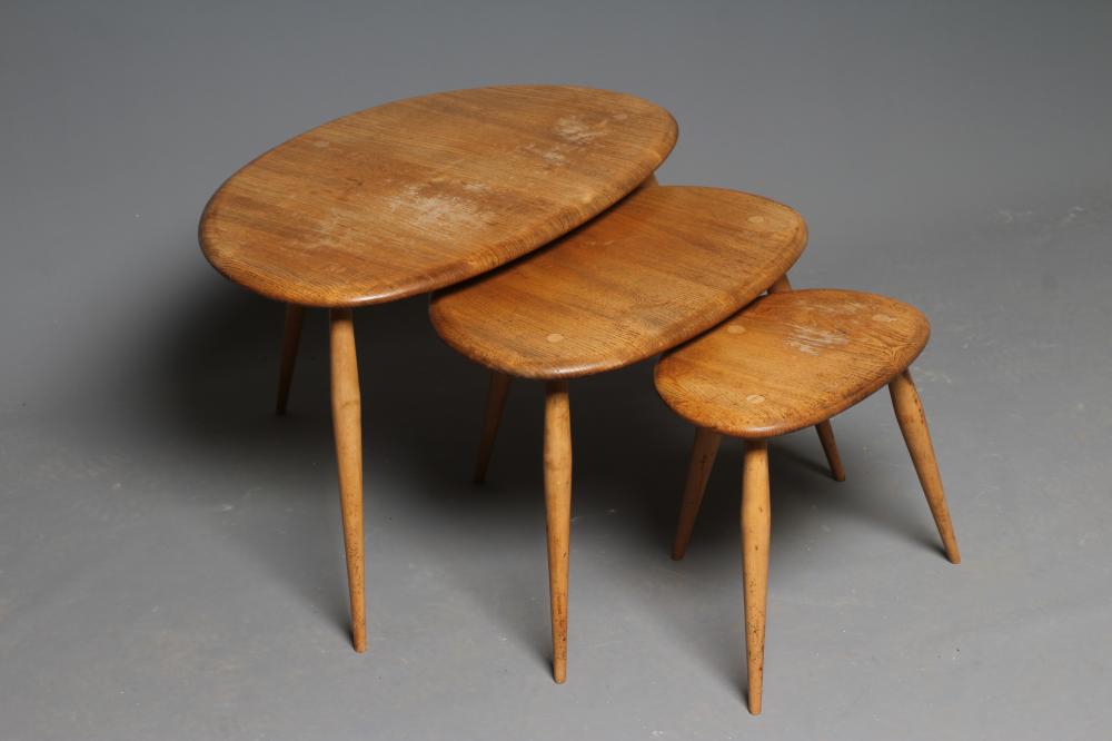 AN ERCOL NEST OF "PEBBLE" TABLES, late 20th century, the blond elm tops on beech legs, largest 26" w Image