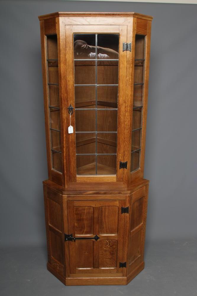 WILFRED HUTCHINSON (HUSTHWAITE) AN OAK STANDING CORNER CUPBOARD Image