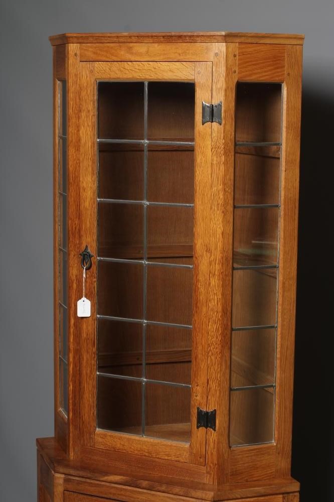 WILFRED HUTCHINSON (HUSTHWAITE) AN OAK STANDING CORNER CUPBOARD Image