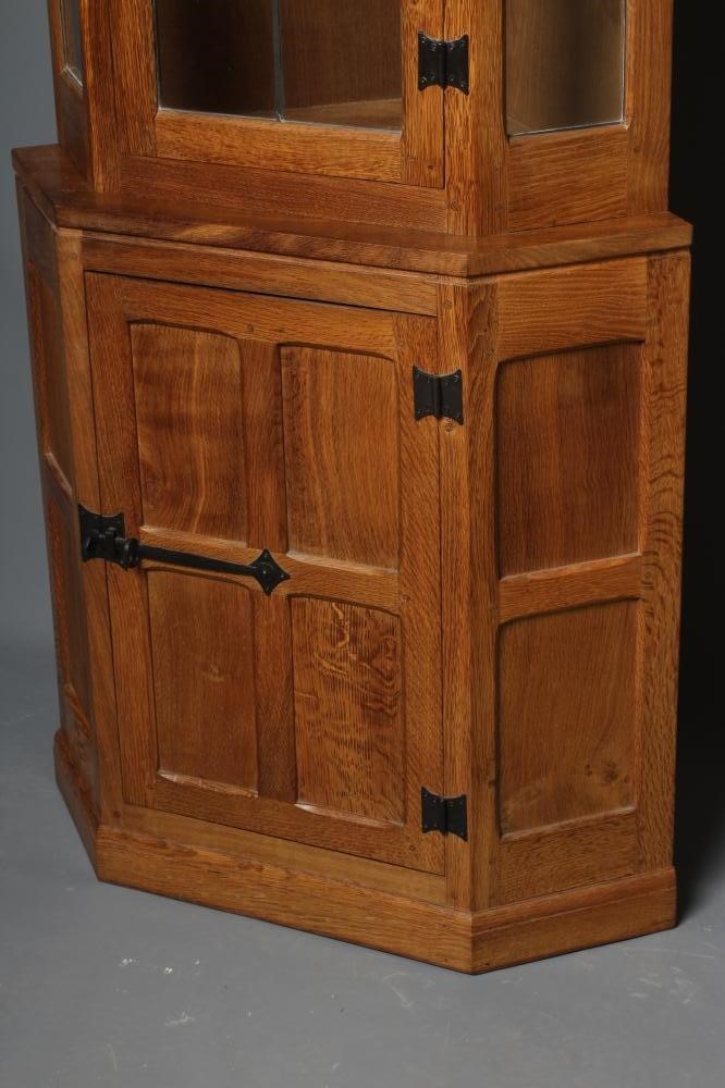 WILFRED HUTCHINSON (HUSTHWAITE) AN OAK STANDING CORNER CUPBOARD Image