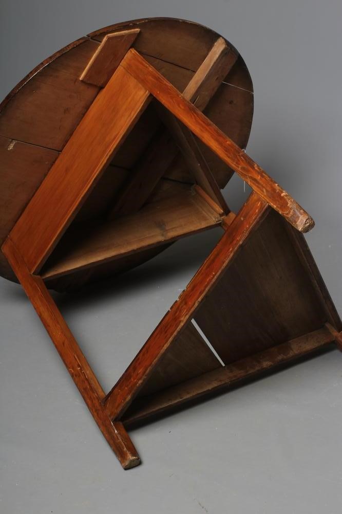 A STAINED PINE CRICKET TABLE, 19th century, the circular plank top and plain frieze on square Image