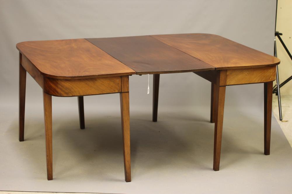 A GEORGIAN MAHOGANY DINING TABLE, c.1800, of rounded oblong form with detachable leaf, plain frieze Image