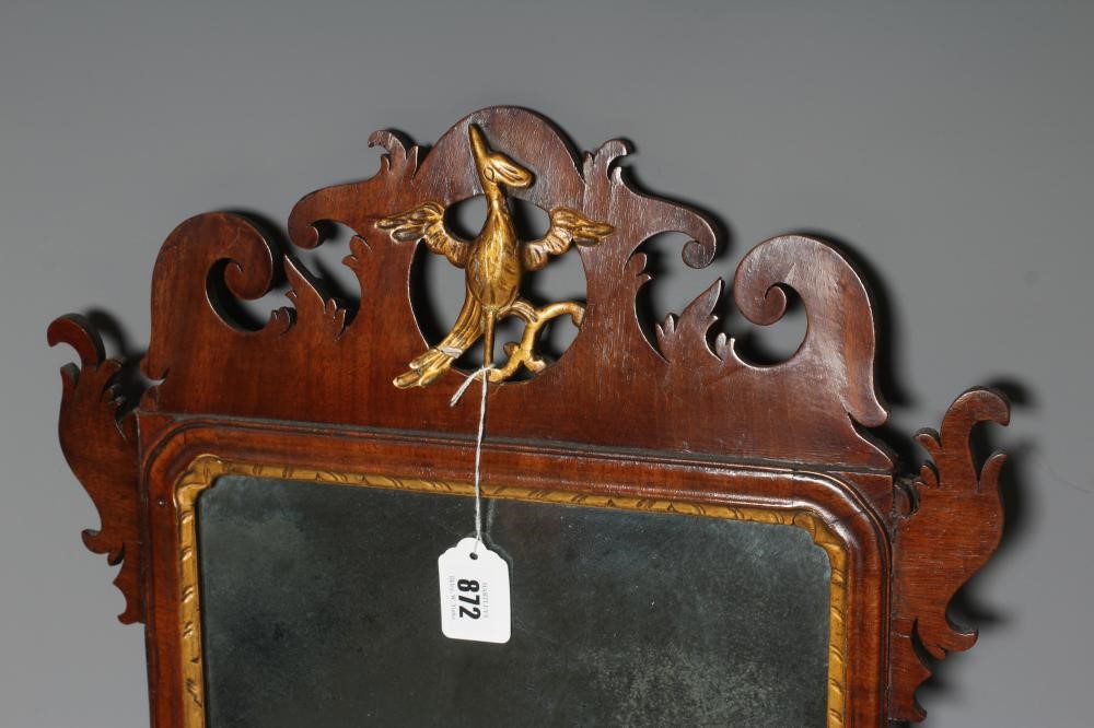 A GEORGIAN MAHOGANY FRET MIRROR, early 19th century, the mildly arched plate within a moulded Image
