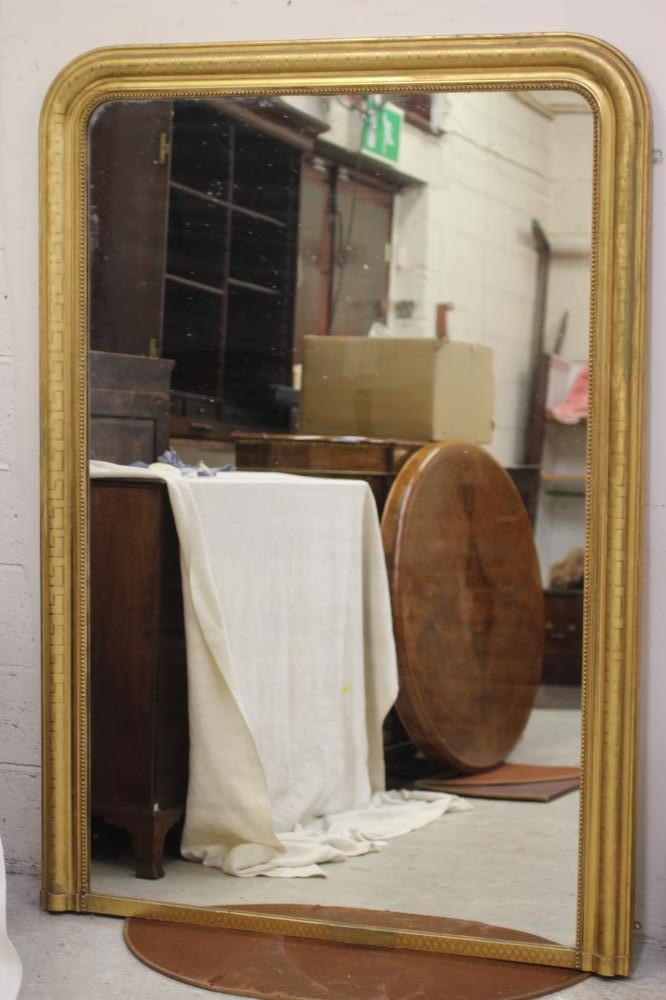 A VICTORIAN GILT GESSO OVERMANTEL MIRROR, the arched plate within a moulded and beaded border with Image
