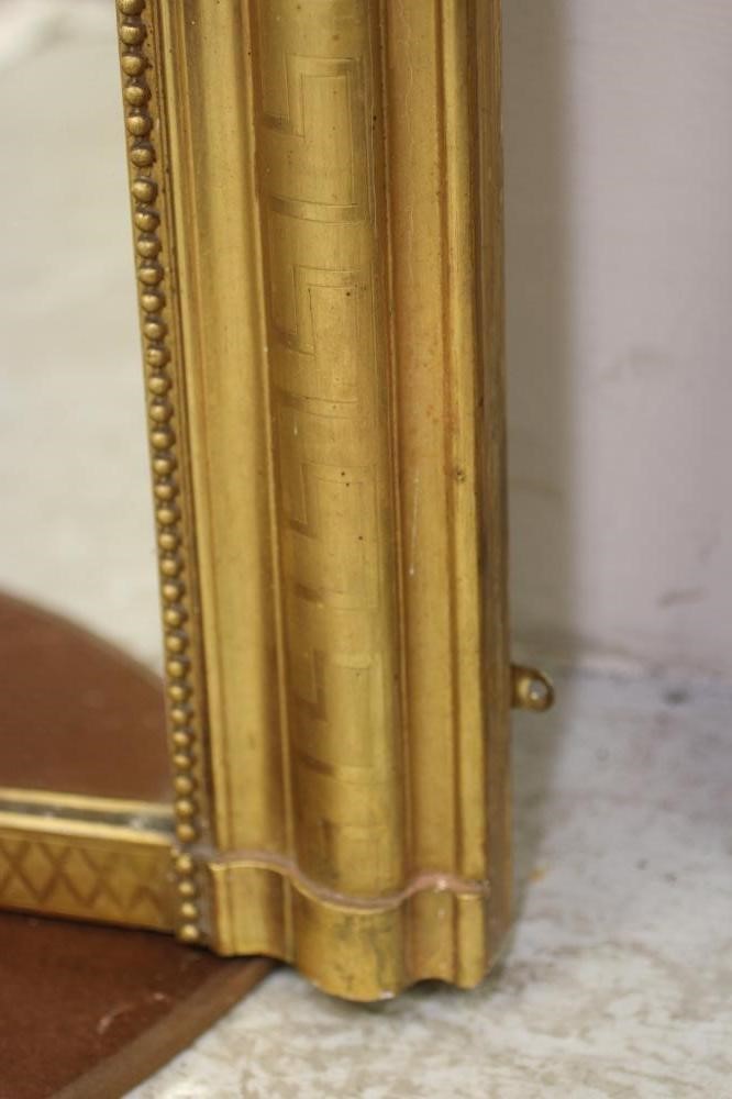 A VICTORIAN GILT GESSO OVERMANTEL MIRROR, the arched plate within a moulded and beaded border with Image