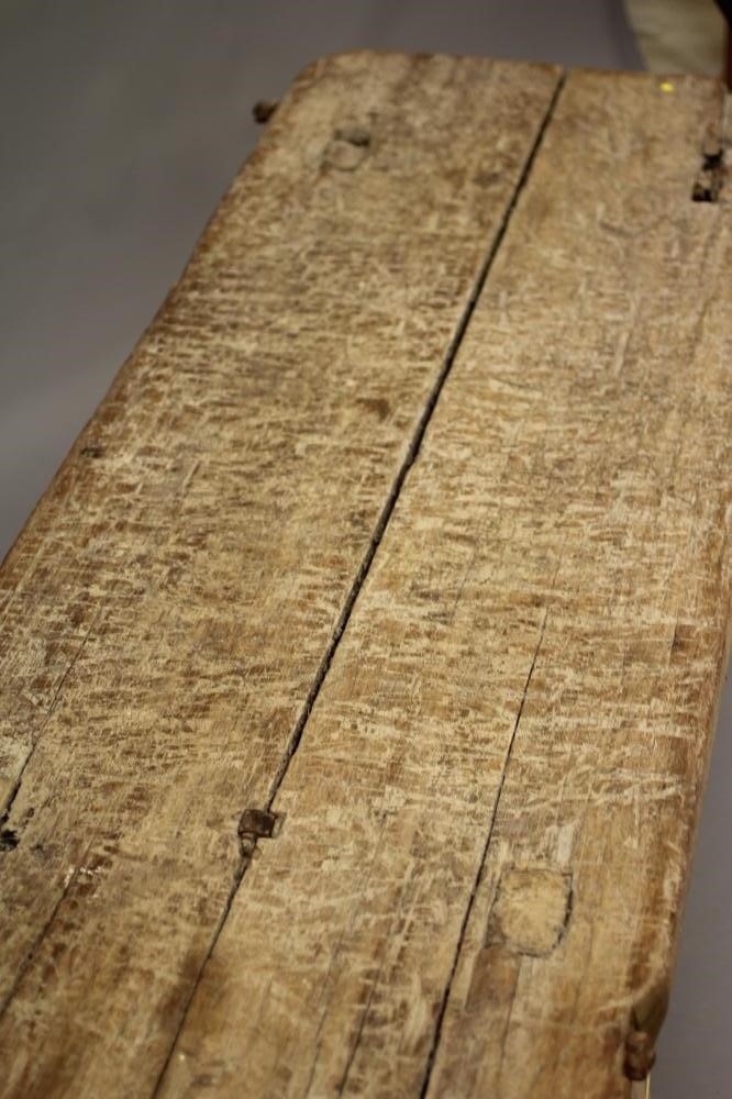 AN ELM PIG BENCH, 19th century, of traditional form, the twin plank top of splayed square section Image