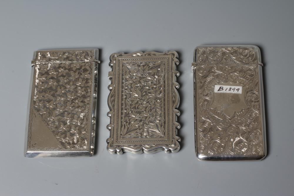 THREE VICTORIAN SILVER VISITING CARD CASES all of vertical oblong form with bright cut engraving Image