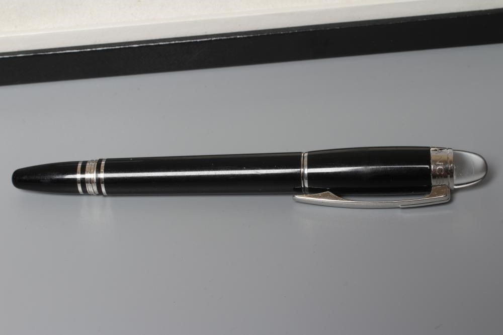 A MONT BLANC BLACK STAR WALKER ROLLERBALL PEN, post 1997, resin with platinum plated mounts, serial Image