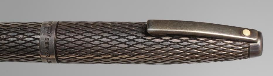 A SHEAFFER STERLING SILVER CARTRIDGE PEN with lozenge engine turning, the pull off cap enclosing 14K Image