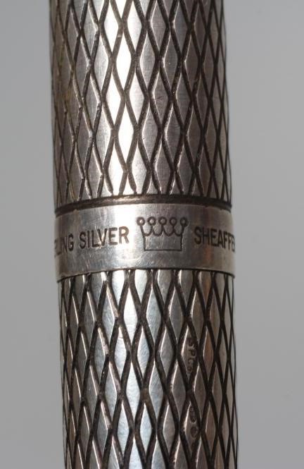 A SHEAFFER STERLING SILVER CARTRIDGE PEN with lozenge engine turning, the pull off cap enclosing 14K Image