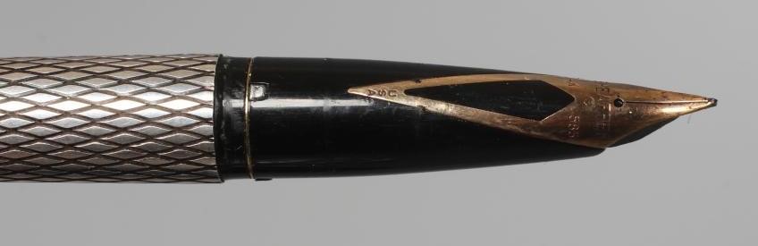 A SHEAFFER STERLING SILVER CARTRIDGE PEN with lozenge engine turning, the pull off cap enclosing 14K Image