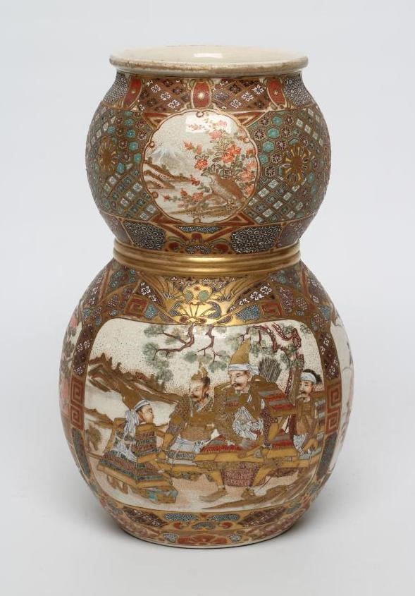 A SATSUMA EARTHENWARE DOUBLE GOURD VASE painted in typical enamels and gilt with two panels of Image