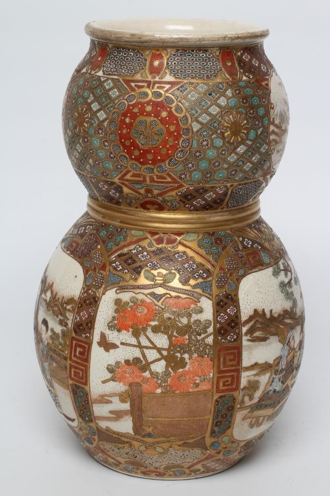 A SATSUMA EARTHENWARE DOUBLE GOURD VASE painted in typical enamels and gilt with two panels of Image