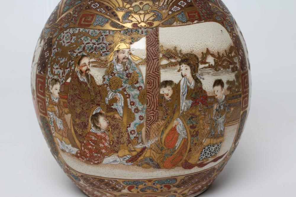A SATSUMA EARTHENWARE DOUBLE GOURD VASE painted in typical enamels and gilt with two panels of Image