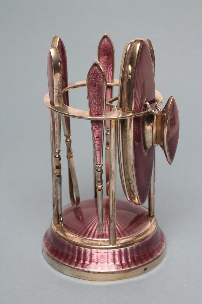 A LADY'S ART DECO LILAC GUILLOCHE ENAMEL AND SILVER EXTENSIVE BOUDOIR SET Image