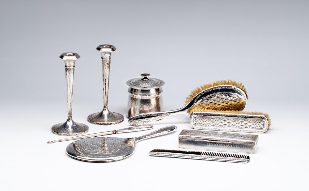 A COMPOSITE SEVEN PIECE ARTS AND CRAFTS SILVER DRESSING TABLE SET Image