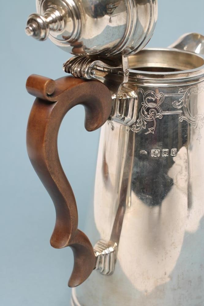 A SILVER COFFEE POT Image