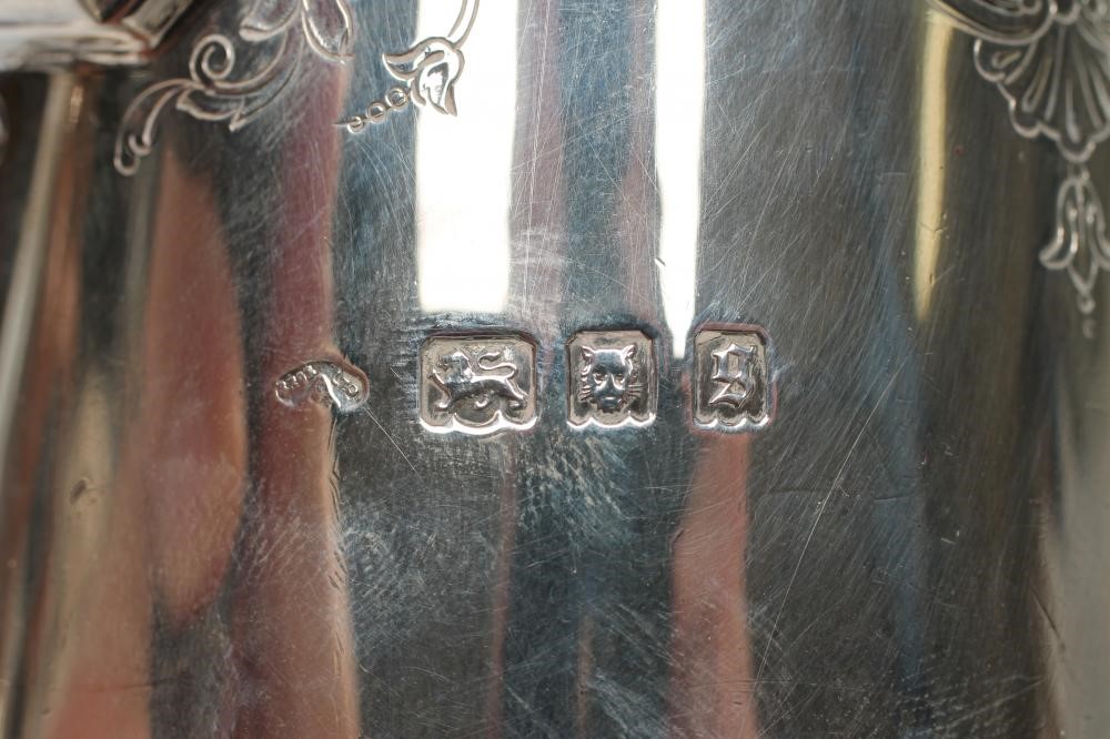 A SILVER COFFEE POT Image