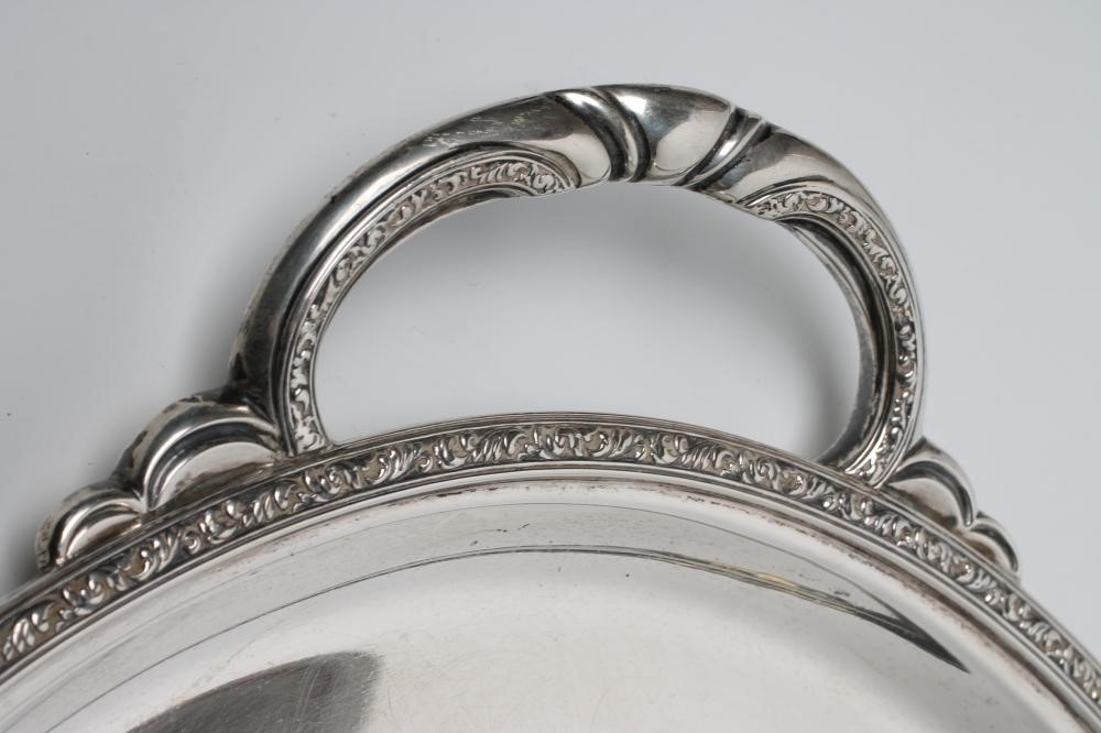 A LARGE SILVER OVAL TWO HANDLED TRAY to match the previous lot Image