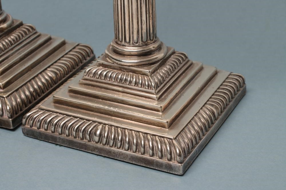A PAIR OF LATE VICTORIAN SILVER CORINTHIAN COLUMN CANDLESTICKS Image