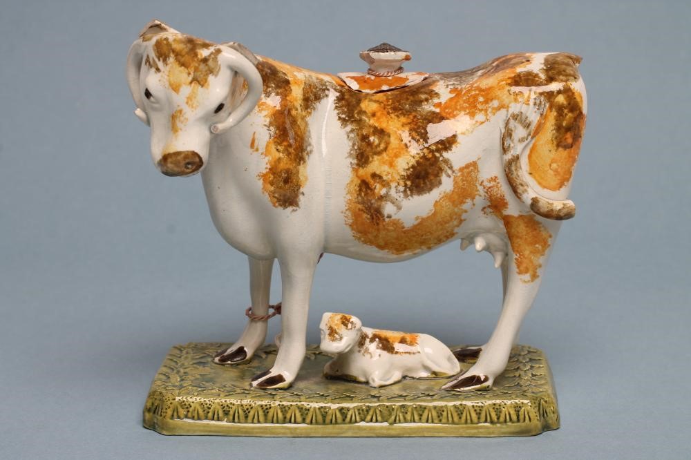 A PEARLWARE COW CREAMER AND COVER Image