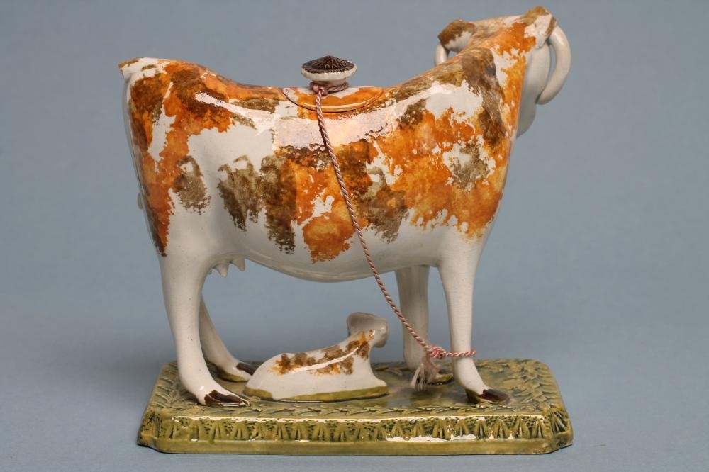A PEARLWARE COW CREAMER AND COVER Image