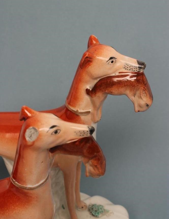 A PAIR OF VICTORIAN STAFFORDSHIRE POTTERY GREYHOUNDS Image