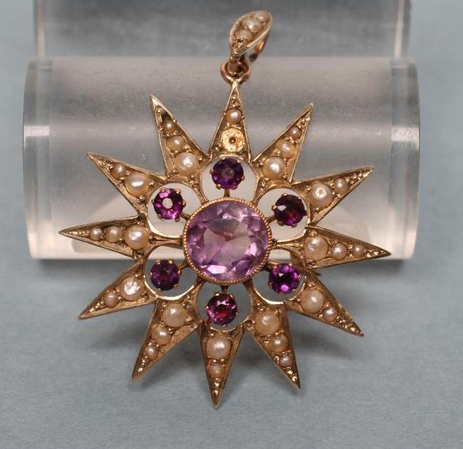 AN EDWARDIAN STAR BROOCH/PENDANT centred by an open back collet set circular facet cut amethyst Image