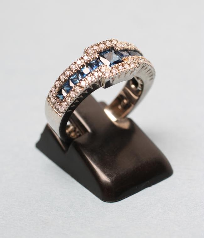 A SAPPHIRE AND DIAMOND HALF HOOP DRESS RING Image