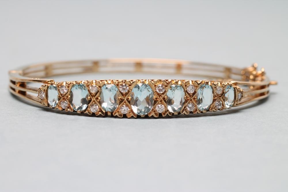 AN AQUAMARINE AND DIAMOND STIFF HINGED BANGLE Image