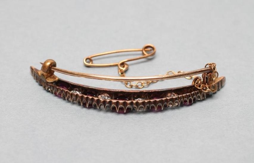 AN EDWARDIAN RUBY AND DIAMOND CRESCENT BROOCH alternately claw set with five graduating rubies and Image