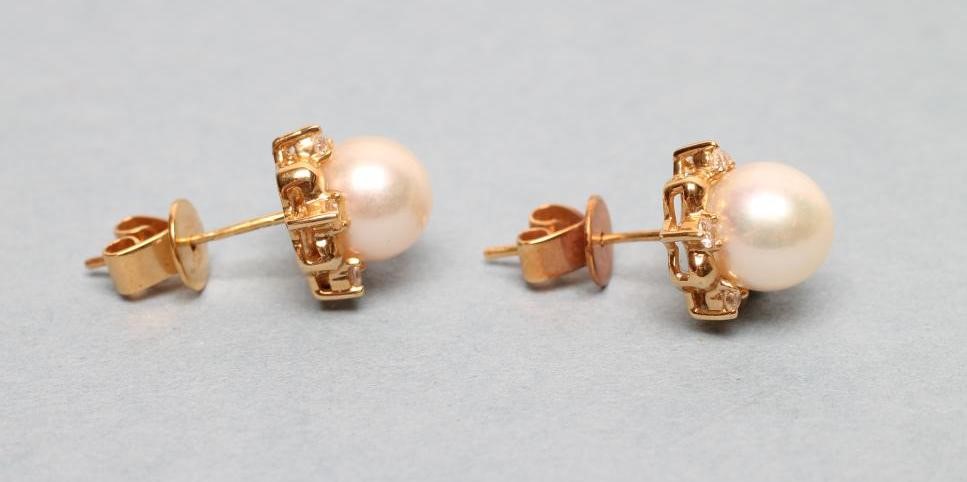 A PAIR OF CULTURED PEARL AND DIAMOND EAR STUDS with plain 18ct gold posts Image