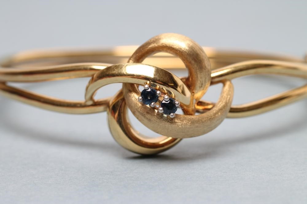A 9CT GOLD STIFF HINGED BANGLE Image