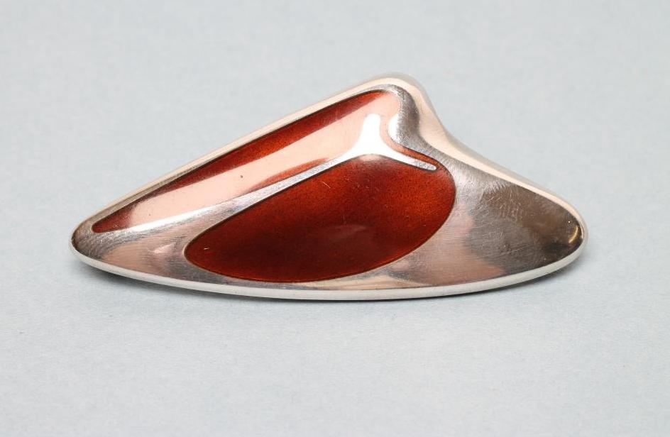 A GEORG JENSEN SILVER BROOCH designed by Henning Koppel with polished brown enamel panel Image
