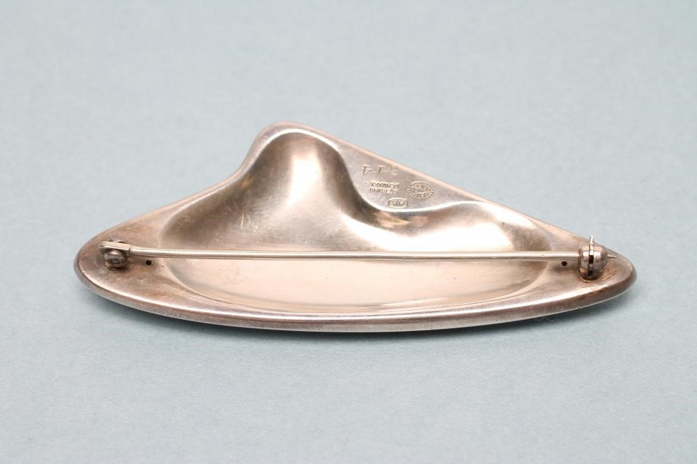 A GEORG JENSEN SILVER BROOCH designed by Henning Koppel with polished brown enamel panel Image
