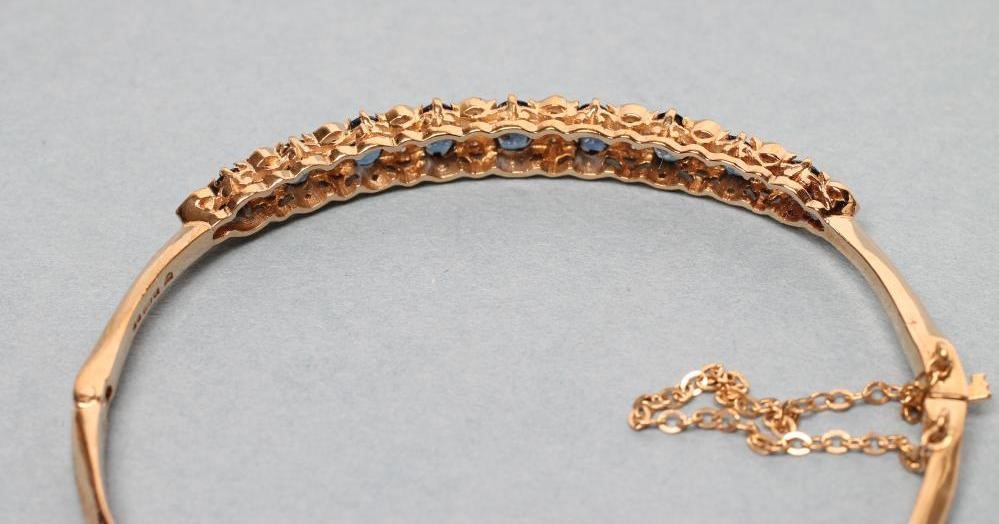 A SAPPHIRE AND DIAMOND STIFF HINGED BANGLE Image