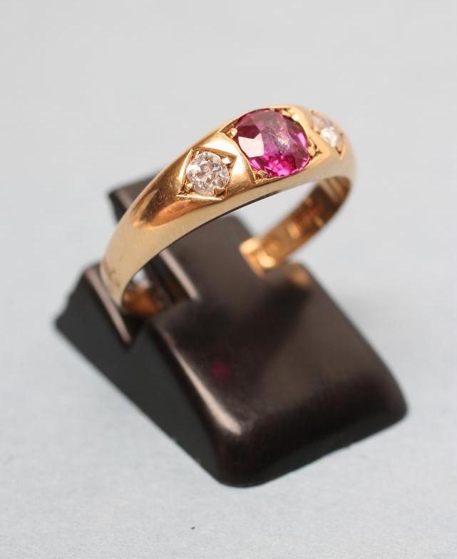 AN EDWARDIAN THREE STONE RUBY AND DIAMOND RING Image
