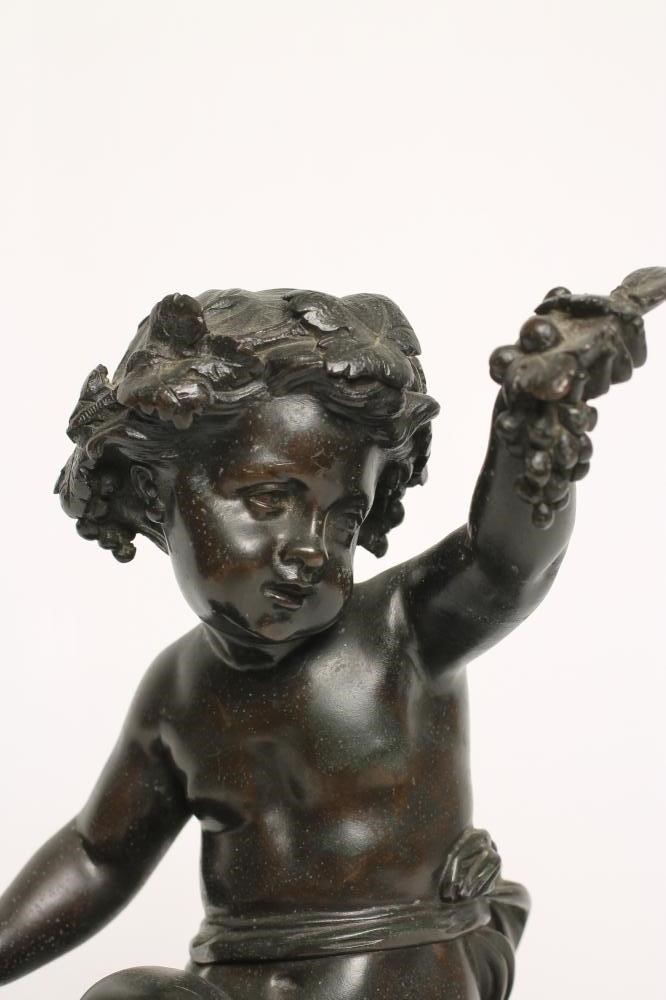 A BRONZE FIGURE OF A BACCHANTE seated on a hod of grapes Image