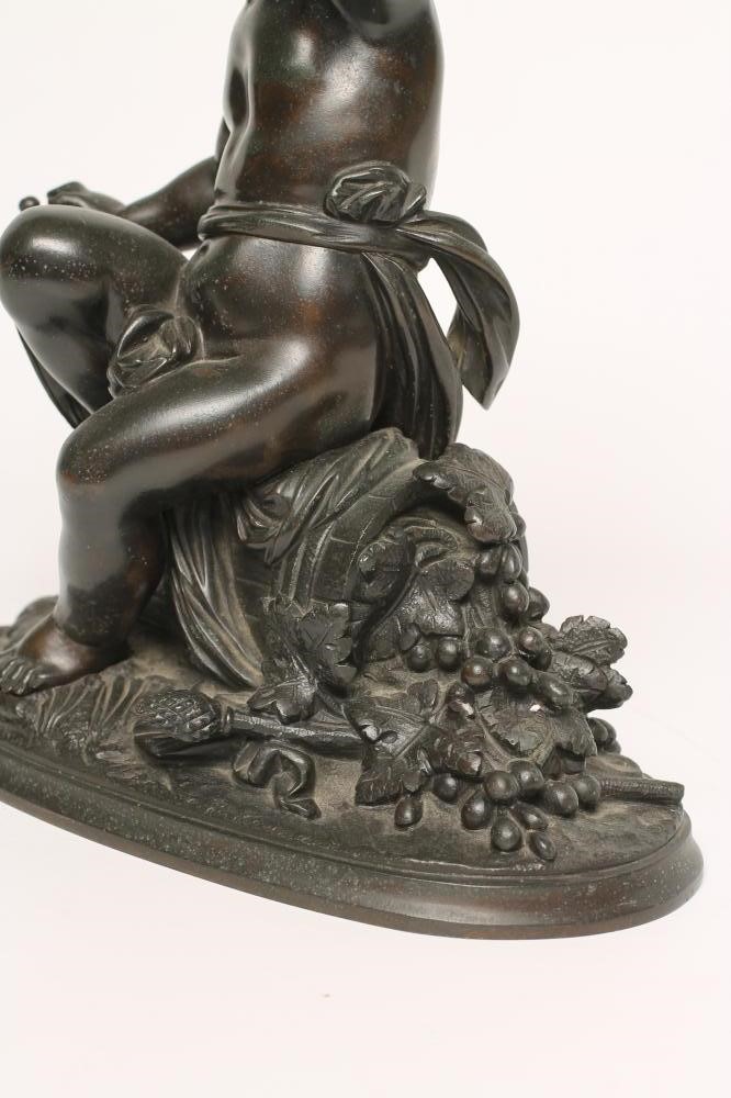 A BRONZE FIGURE OF A BACCHANTE seated on a hod of grapes Image