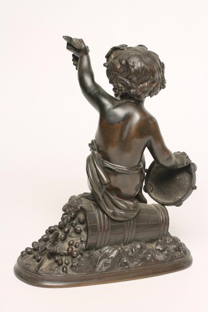 A BRONZE FIGURE OF A BACCHANTE seated on a hod of grapes Image