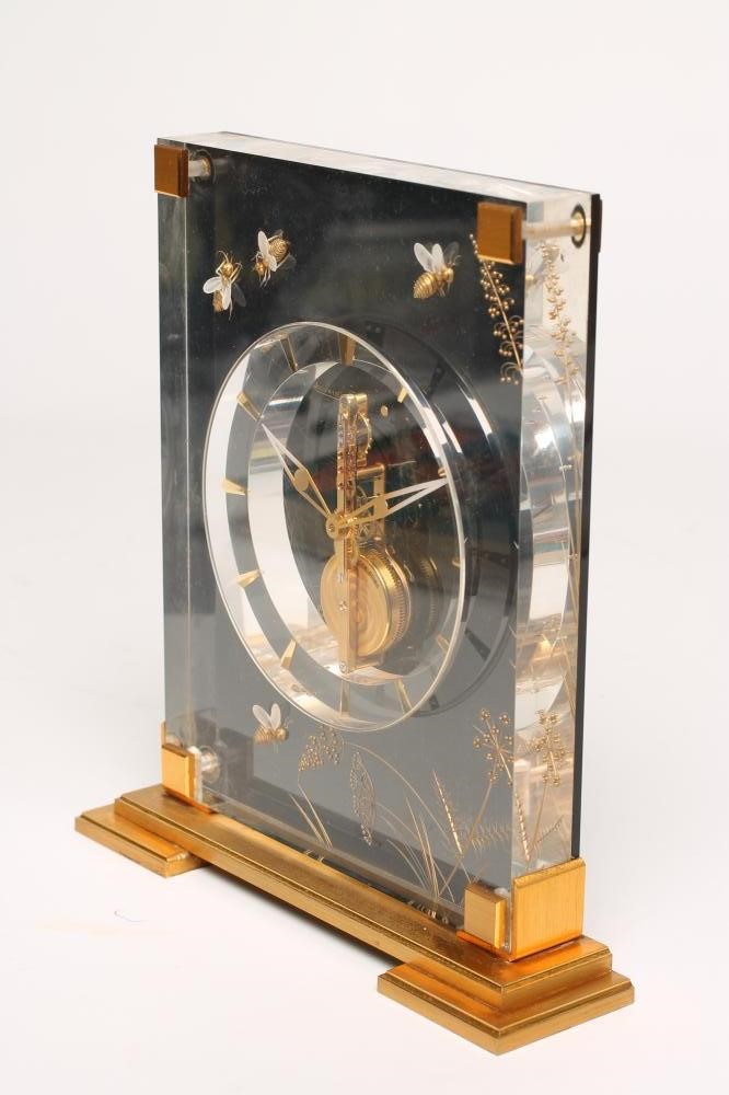 A JAEGER LECOULTRE GILT METAL AND PERSPEX MYSTERY TIMEPIECE Image