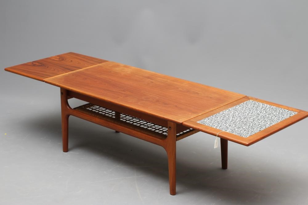 A RETRO MID CENTURY TEAK COFFEE TABLE of oblong form with sliding end extensions Image